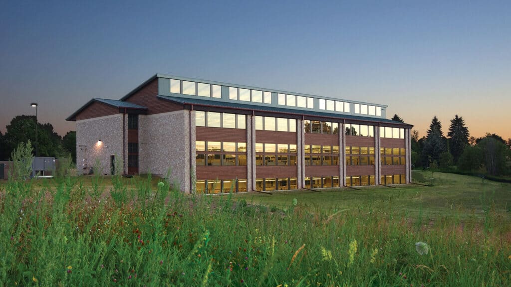 Office Construction - exterior view of corporate office building surrounded by green fields