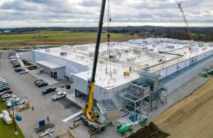 Aerial view of heavy equipment installation outside food and beverage manufacturing facility