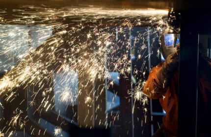 Welder at work with sparks coming off weld site