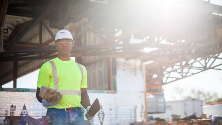 Boldt masonry worker holding bricks on jobsite