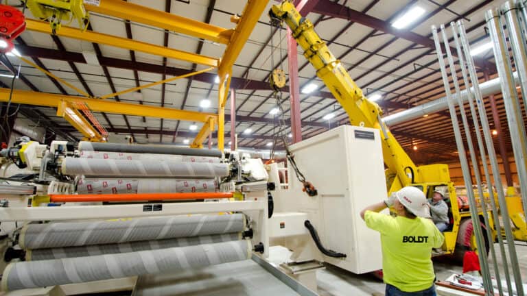 Two employees working together during equipment installation