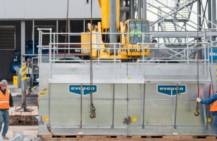 Boldt Technical Services - construction workers preparing to hoist equipment for equipment installation using a crane