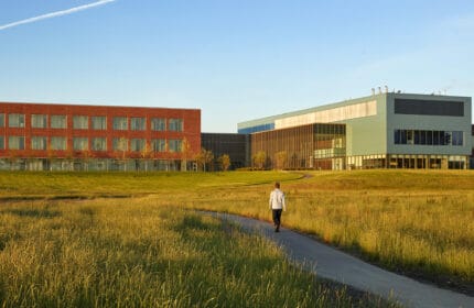 Pedestrian on walking path outside Aurora Southern Lakes