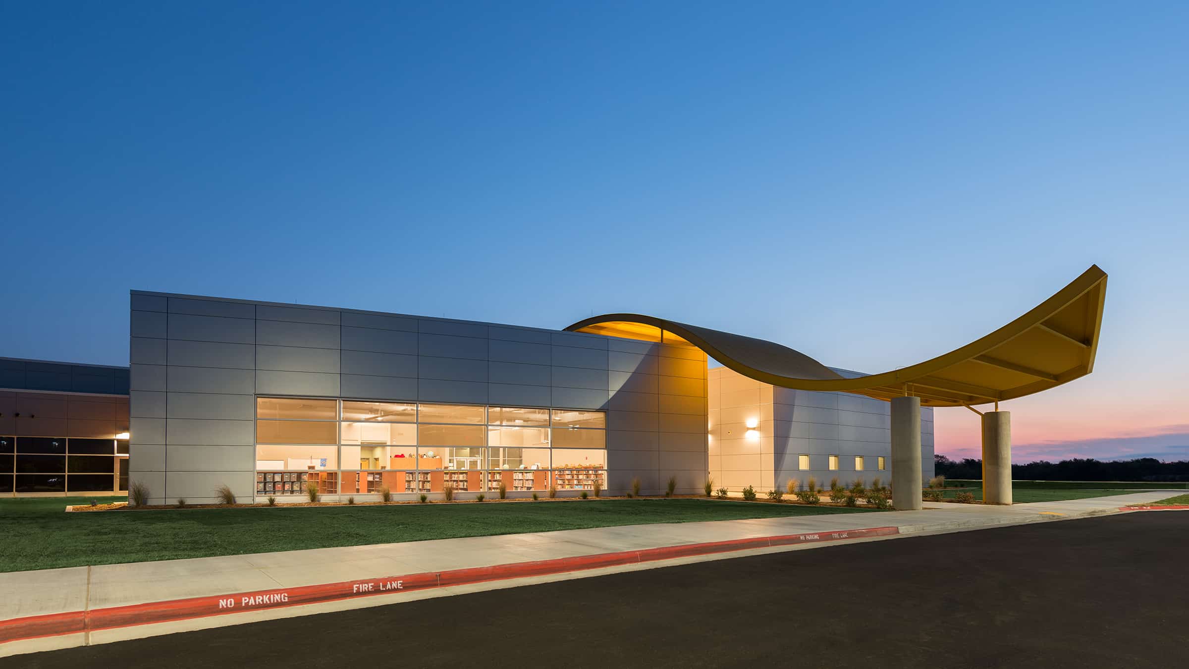 Broken Arrow Public Schools - Highland Park Elementary School Exterior on Site with Drive Lit at Night