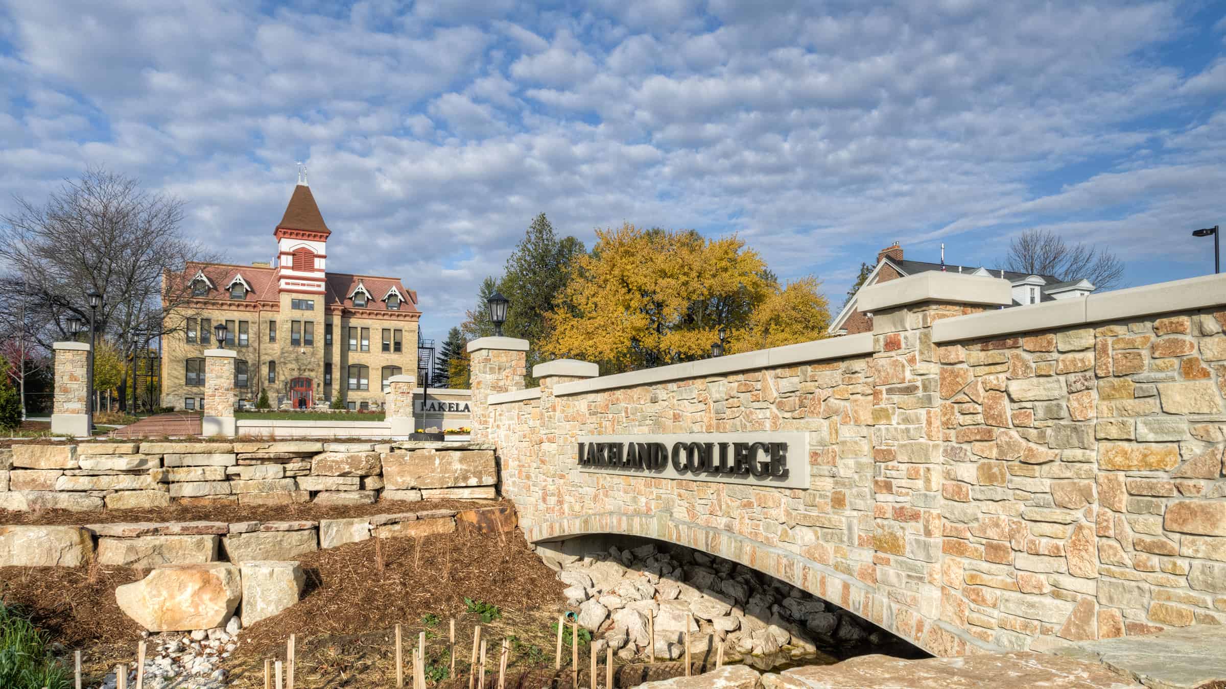 Lakeland University - Campus Entrance Redevelopment Construction of Stone Bridge with Signage with View of Campus