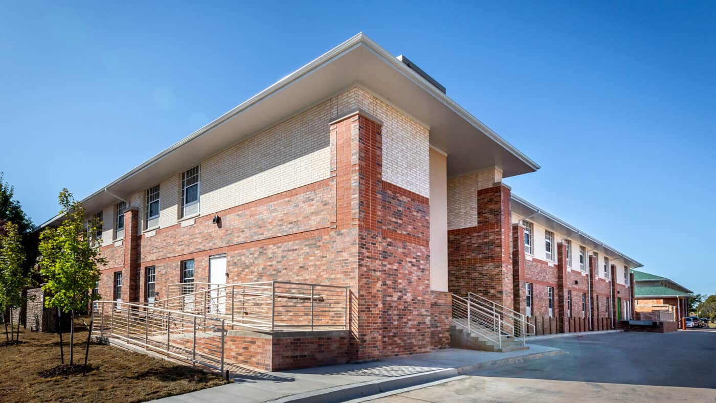 Spanish Cove Retirement Community Exterior of Building with Resident Entrance and Ramp for Accessibility