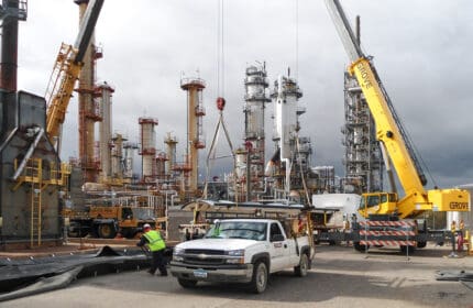 St. Paul Park Refinery, Mutiple Cranes on Site during Construction and Equipment Installation, with Boldt Employee and Truck in Foreground