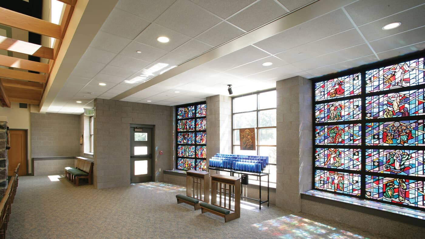 St. Paul's Catholic Church Interior with Stained Glass Windows and Rack of Votive Candles with Kneelers