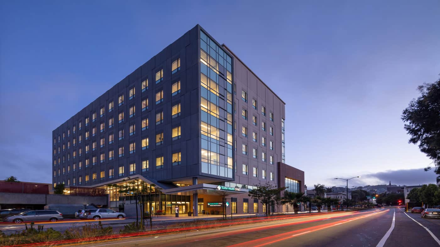 Sutter Health - CPMC - Mission Bernal Campus Hospital Exterior View of Building, Lit at Dusk from Street