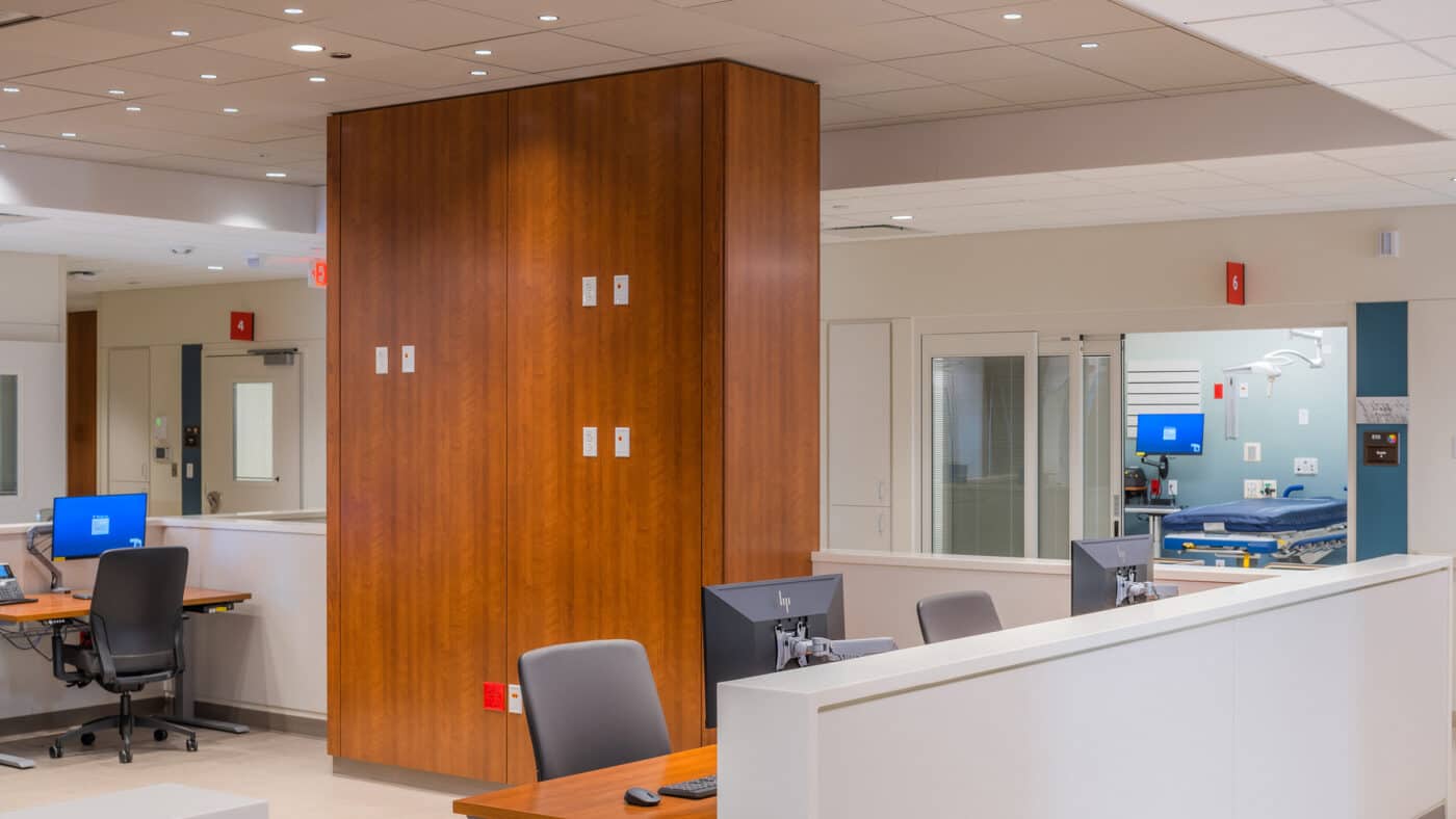 ThedaCare Medical Center - Berlin - Emergency Department Staff Desks in Foreground, Patient Room in Backgroun