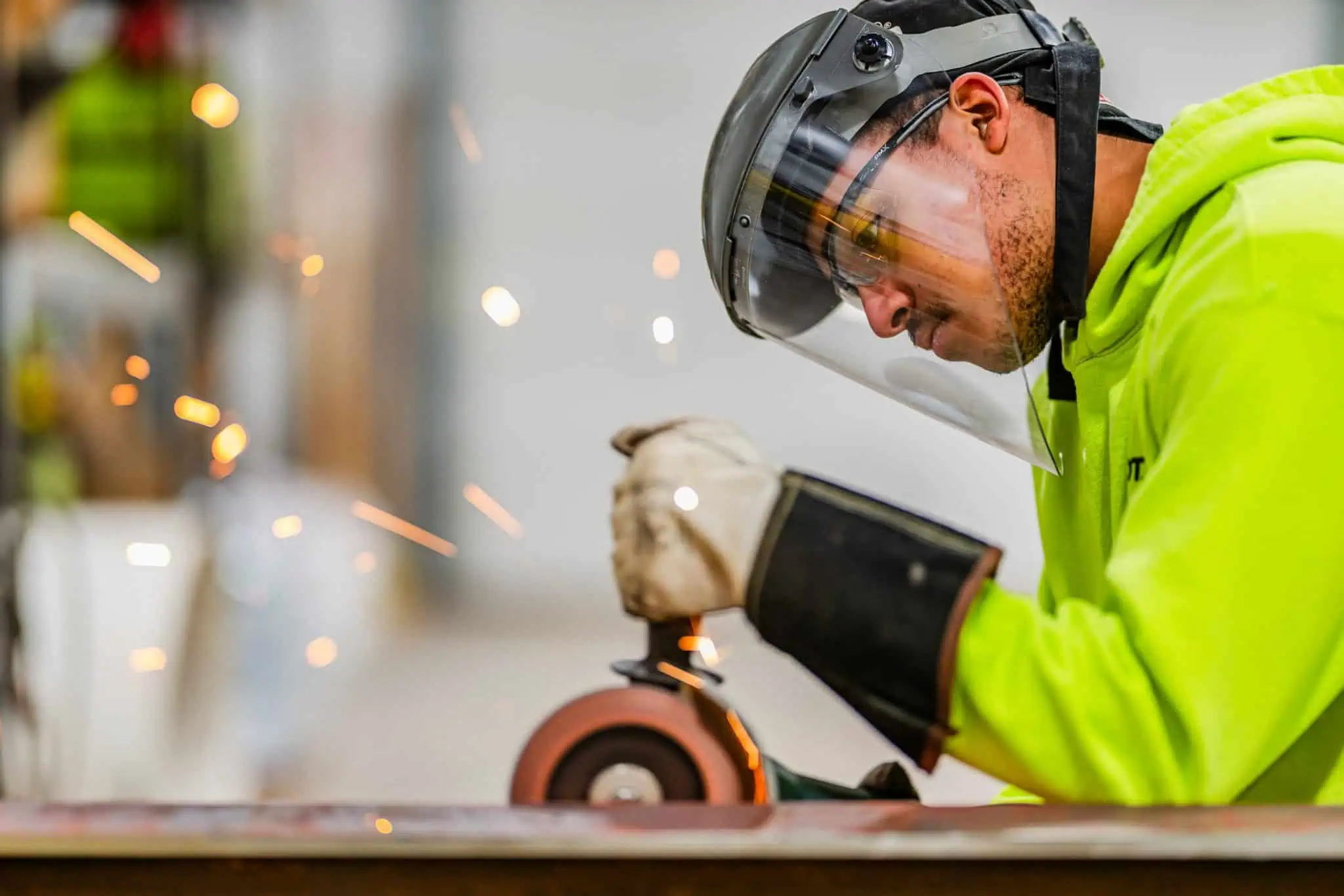 employee working with saw wearing safety gear