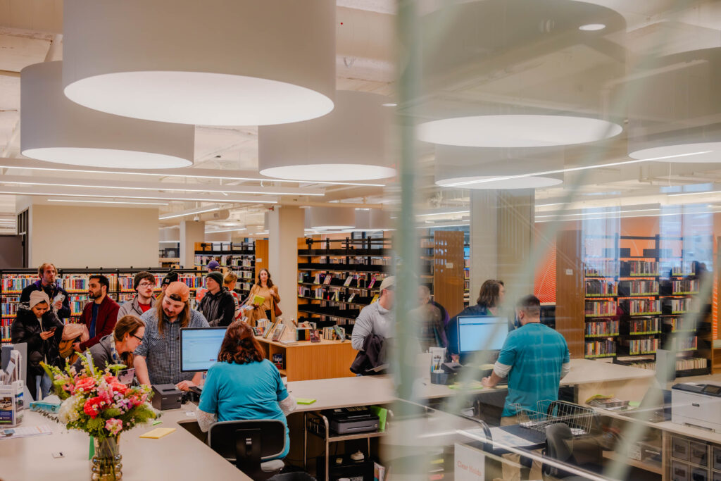 Books being checked out for the first time at the ribbon cutting ceremony for the Appleton Public Library.